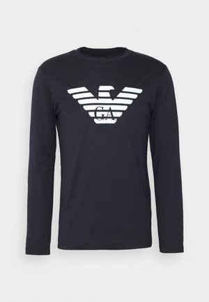 Navy long-sleeve t-shirt made of cotton, featuring a white eagle logo with striped design at the chest, round neckline, and fitted sleeves.