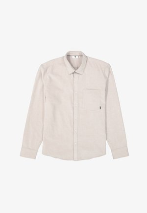 Camisa de manga larga color beige claro, hecha de tejido texturizado, con cuello de botón, bolsillo frontal y dobladillo curvo.