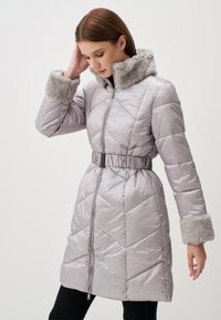 Cappotto imbottito grigio chiaro con colletto e polsini in pelliccia sintetica, vita con cintura e texture trapuntata, dotato di zip frontale e tasche laterali.