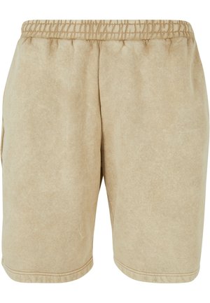 Shorts atletici beige realizzati in tessuto morbido, dotati di una cintura elastica e tasche laterali, con una vestibilità comoda e una texture liscia.