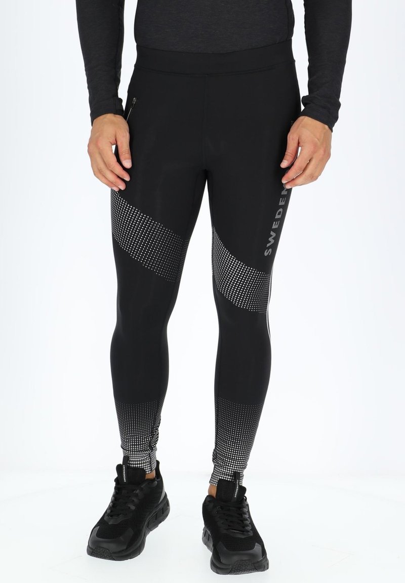 Zwarte sportleggings met een gestippeld patroon en een zijzak met rits. Gemaakt van een gladde, rekbare stof voor optimaal comfort.
