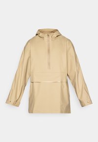 Beige Regenjacke mit Kapuze, halbem Reißverschluss an der Vorderseite und langen Ärmeln. Glattes, wasserabweisendes Material mit einem glänzenden Akzent an der Taille.
