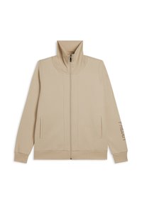 Giacca beige con zip e colletto alto, cuciture piatte, tasche laterali e dettagli stampati sulla manica destra. Realizzata in tessuto morbido e liscio.