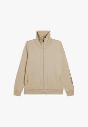 Giacca beige con zip e colletto alto, cuciture piatte, tasche laterali e dettagli stampati sulla manica destra. Realizzata in tessuto morbido e liscio.