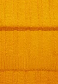 Tissu jaune texturé, présentant des motifs de côtes verticales. Texture douce et duveteuse avec une teinte vive, idéal pour les vêtements ou les textiles d'ameublement.