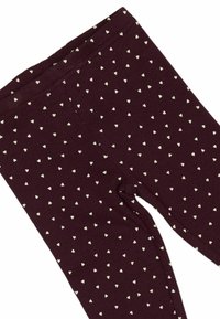 Bordeaux leggings lavet af ribbet stof, med et spredt hvidt hjerte mønster. Elastisk talje uden synlige detaljer.