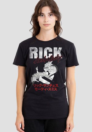 Young woman wearing a black Rick and Morty t-shirt with characters and text in English and Japanese on a plain background.