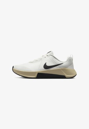 White athletic shoes with mesh upper, black Nike swoosh, neutral-toned midsole, and contrasting textured black outsole.