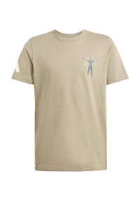 Beige puuvillapaita lyhyillä hihoilla, jossa on siluettigrafiikka rinnassa ja kiinteä valkoinen yksityiskohta vasemmassa hihassa.