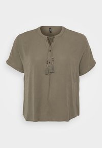 Khaki short-sleeve blouse with a round neckline, front button closure, and decorative tassels with beads at the tie detail. Smooth fabric texture.