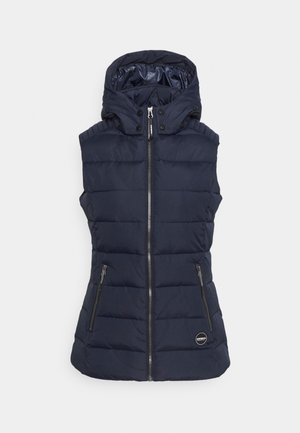 Veste matelassée sans manches bleu marine avec fermeture éclair avant, capuche avec boutons-pression, deux poches zippées et un petit logo circulaire près de l'ourlet.