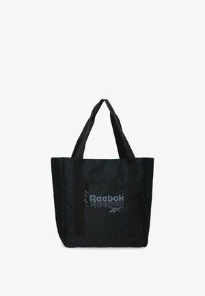 Bolsa tote negra de Reebok con doble asa para el hombro y bolsillo frontal con cremallera que muestra el logo de Reebok en letras grises.