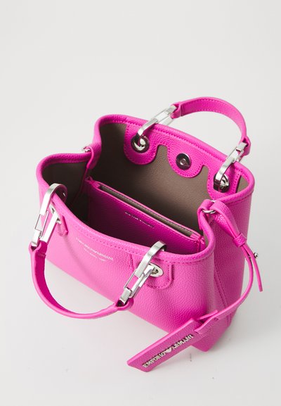 Bright pink leather handbag with dual handles, silver hardware, partially open showing interior pocket and matching pink tag.