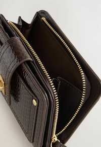 Brown crocodile-textured wallet with gold zipper, featuring multiple compartments and a snap closure. Interior lined in dark fabric.
