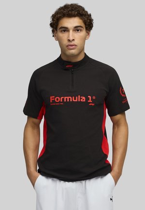 Mustat ja punaiset puoleen vetoketjun urheilupaita, jossa on "Formula 1" -logo, lyhyet hihat ja teksturoitu kangas. Yksinkertainen selkä ilman lisägrafiikoita.