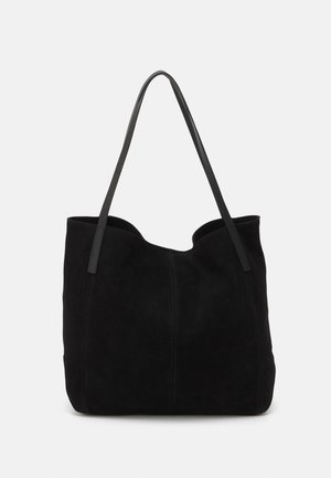 Black suede tote bag with two long leather straps, featuring a smooth texture and a scalloped top. Simple design with no prominent hardware.