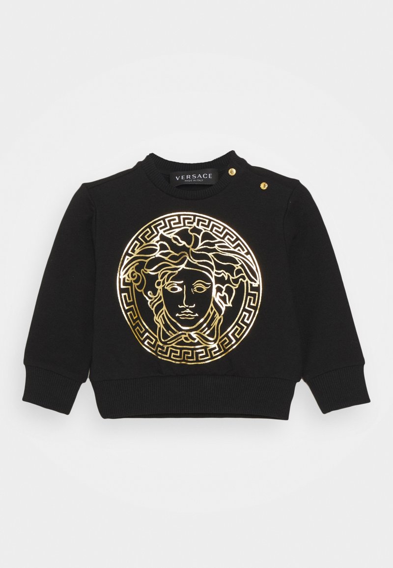 Sweat-shirt bébé noir à manches longues avec tête de Méduse dorée et motif clé grecque sur le devant, avec deux boutons dorés sur l'épaule.