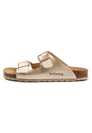 Sandale dorée à enfiler avec deux sangles réglables, semelle en liège et semelle en caoutchouc texturée. Logo "billowy" imprimé sur le côté.