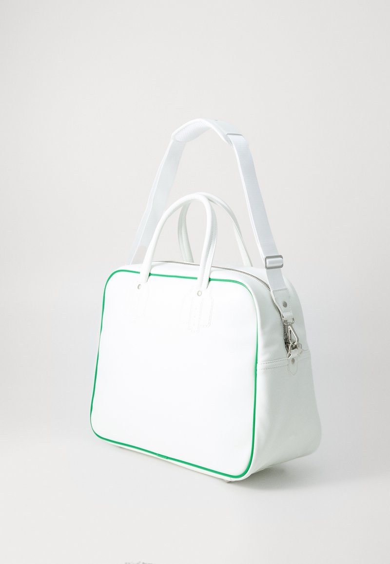 White handbag made of smooth synthetic material with green piping. Features two top handles and a detachable shoulder strap. Rectangular shape.