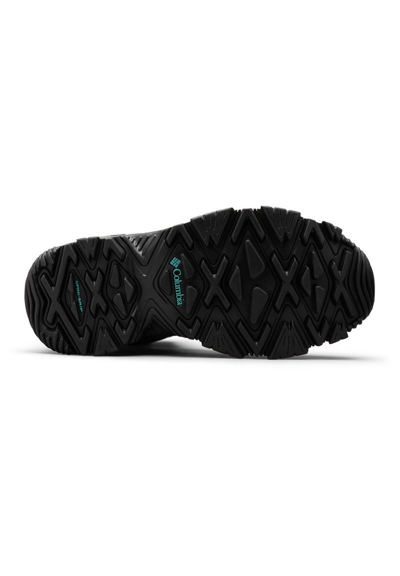 Semelle en caoutchouc noir avec des crampons multidirectionnels pour une meilleure traction, arborant un logo de marque proéminent et une surface texturée pour une meilleure adhérence.