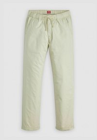 Pantalon casual beige clair avec ceinture élastique et cordon, doté de poches latérales et de jambes droites.