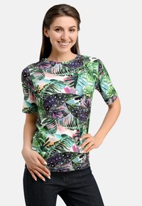 Short-sleeved T-shirt made of stretchy fabric featuring a vibrant tropical leaf pattern in green, purple, and pink.
