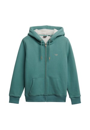 Sudadera con cremallera en color verde azulado, con un suave forro de felpa blanca. Presenta cordones con puntas doradas, bolsillos frontales y un pequeño logo en el pecho.