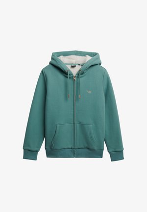 Teal lynlås-trøje med blød, hvid fleece-foring. Har snoretræk med gyldne spidser, forlommer og et lille logo på brystet.