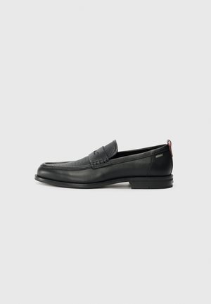 Black leather loafers with a textured front panel and smooth sides. Features a slim heel and rear loop for easy wear. Classic design.
