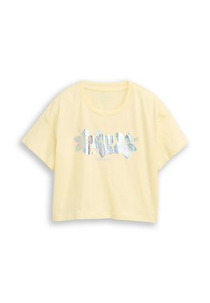 Light yellow short-sleeve cropped t-shirt with iridescent floral graphic across the chest and round neckline.