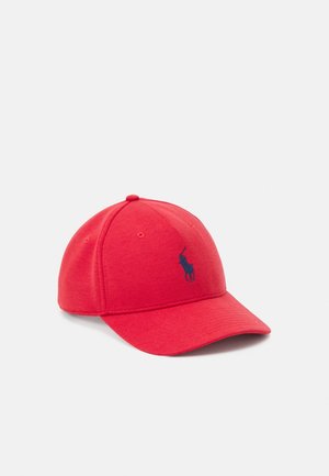 Berretto da baseball rosso con visiera curva e logo ricamato di un giocatore di polo blu navy sul pannello anteriore, mostrato su uno sfondo semplice.