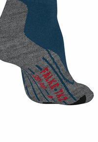 Grau und Teal Socken mit einem strukturierten Fußbett, rotem Logo und subtilen Wellenmuster. Verstärkte Fersen- und Zehenbereiche für Langlebigkeit.