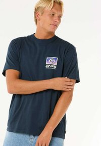 Navy blue cotton t-shirt with a relaxed fit, featuring a squared graphic logo on the chest in purple, white, and black colors.