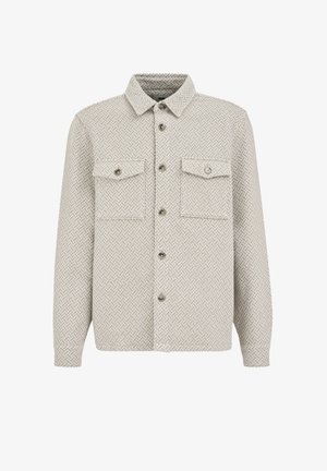 Helehall beežikas särk-jakk, millel on terav krae, kaks eelmist taskut nööbikoobastega ja nööbitav esipaneel.