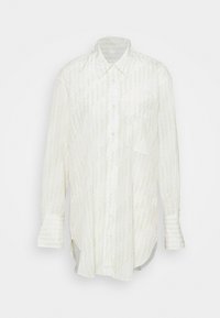 Chemise blanche à boutons avec un motif en zigzag vert clair, manches longues, poche poitrine unique, coupe décontractée et tissu au toucher doux.