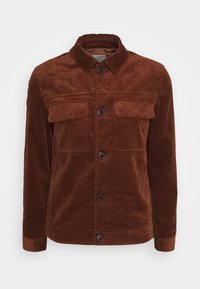 Brun kordfløjlsjacka med långa ärmar, knappstängning, två bröstfickor och ribbat mönster. Kragdesign med subtila horisontella linjer.