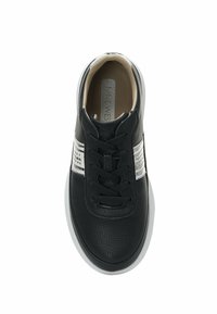 Black textured leather sneaker with white stripe detail, rounded toe, and black laces. Features padded collar and white rubber sole.