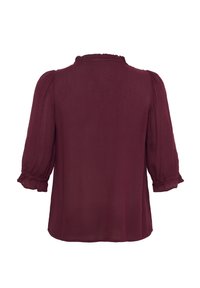 Blouse bordeaux avec des manches bouffantes trois-quarts, un col froncé et un tissu lisse et léger. La vue de dos montre une coupe décontractée.