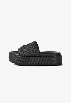 Black slide sandal with a thick woven platform sole and wide woven strap across the top.