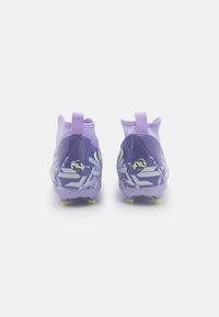 Purple soccer cleats featuring a snug fit, textured upper, and yellow accent details, with a patterned lower design and molded stud outsole.