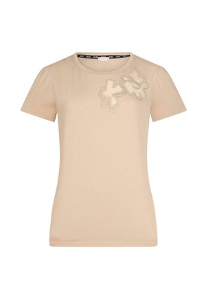 T-shirt beige à manches courtes en coton avec un col rond, présentant une broderie florale en relief et des détails de couture contrastants.