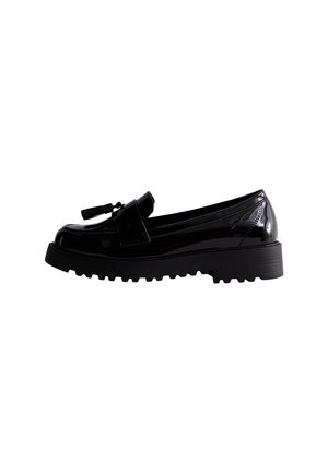Sorte loafers i laklæder med en tyk, struktureret sål og dekorative kvastdetaljer. Har rundet snude og design med let påtagning.