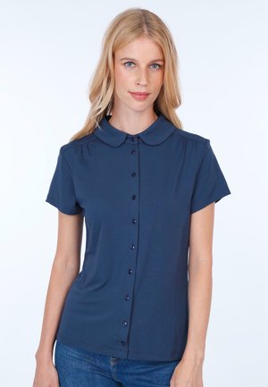 Navy blue short-sleeve blouse with a button front, a round collar, and subtle pleats on the shoulders. Soft fabric with a smooth texture.