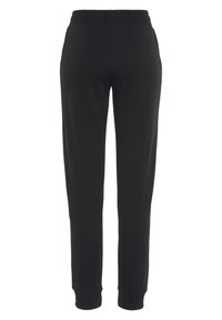 Schwarze Jogginghose aus weichem Stoff, mit elastischem Bund, tailliertem Bein und gerippten Bündchen. Schlichtes und funktionales Design ohne Taschen.