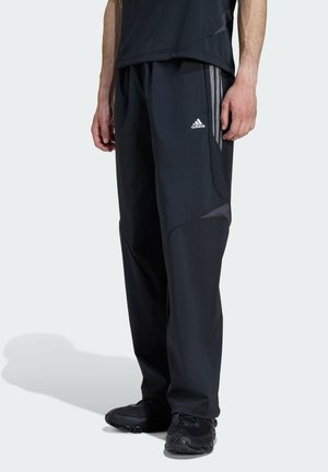 F50 LOOSE STRIPED - Tracksuit bottoms - black