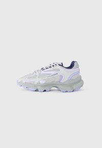 Lacoste sneakers feature a gray mesh upper with purple accents, a chunky gray sole, padded collar, and contrasting laces.
