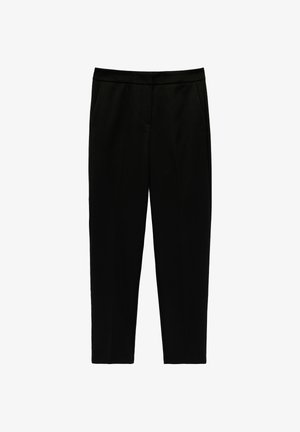 Pantalon noir fuselé longueur cheville avec poches latérales et ceinture plate, présenté sur fond blanc.