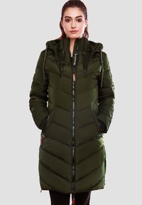 Padded long coat in dark green, features zip closure, adjustable hood, chevron pattern, side pockets, and contrasting zipper pulls.