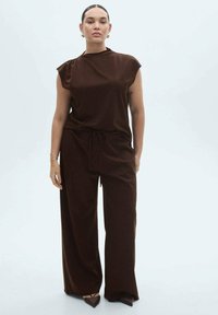 Brown, loose-fitting two-piece outfit with a high neckline top and wide-leg trousers. Smooth fabric and minimalistic design.