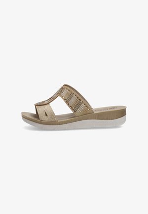 Infradito d'oro con un cinturino lucido caratterizzato da decorazioni trasparenti. Soletta testurizzata e suola bianca flessibile per il massimo comfort.